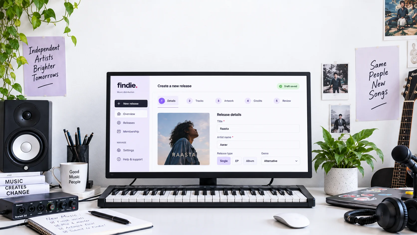 A bright music studio with a keyboard, speakers and Findie's lavender release workspace on a monitor